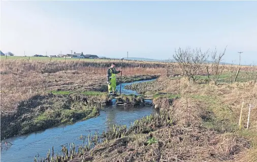  ??  ?? HISTORIC FIND: A researcher at work on the study which found evidence of a Viking waterway running through mainland Orkney