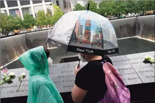  ?? John Minchillo / Associated Press ?? Visitors browse the south pool at the National September 11 Memorial & Museum in New York.