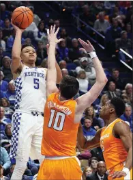  ?? AP/JAMES CRISP ?? Kentucky’s Kevin Knox (left) shoots while defended by Tennessee’s John Fulkerson (10) and Admiral Schofield (5) during the first half Feb. 6 in Lexington, Ky. Knox, a freshman, is averaging 15.1 points to lead the Wildcats, who will take on the Razorbacks at 8 tonight at Walton Arena.