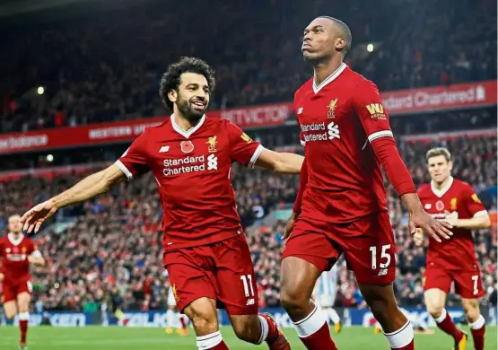  ??  ?? On the goal-den trail: Liverpool’s Daniel Sturridge celebratin­g with Mohamed Salah after scoring against Huddersfie­ld on Saturday. — Reuters