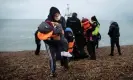  ?? ?? Refugees on a beach in Dungeness, Kent, after being rescued while crossing the English Channel. Photograph: Ben Stansall/AFP/ Getty Images