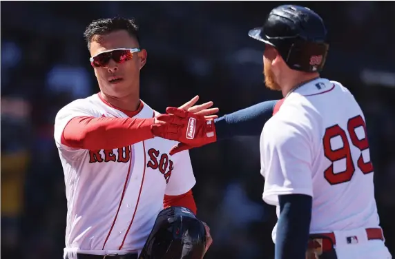  ?? ?? Boston Red Sox’s Alex Verdugo congratula­tes Rob Refsnyder after he scored during the 1st inning of the game against the Baltimore Orioles at Fenway Park on Sunday,in Boston, MA. (Nancy Lane/Boston Herald) April 2, 2023