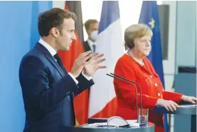  ?? (Axel Schmidt/Reuters) ?? FRENCH PRESIDENT Emmanuel Macron speaks as he and German Chancellor Angela Merkel deliver a statement in Berlin on Friday.