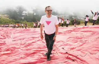  ?? Paul Chinn / The Chronicle ?? Patrick Carney, who came up with the idea of placing the pink triangle on Twin Peaks, celebrates after more than 100 volunteers installed it in record time to kick off Pride Weekend.