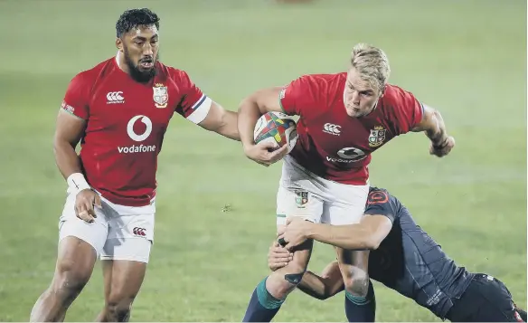  ??  ?? Duhan van der Merwe (centre) of The British & Irish Lions is tackled by Jeremy Ward of the Cell C Sharks during the Castle Lager Lions Series match.