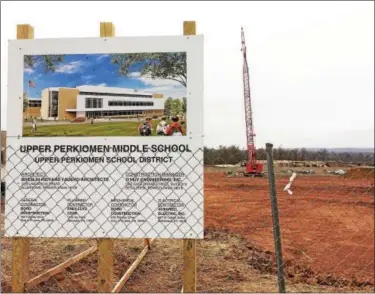  ?? EVAN BRANDT — DIGITAL FIRST MEDIA ?? The sign in front of the constructi­on site on Montgomery Avenue shows what the new middle school was designed to look like.