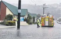  ?? PHOTO: PETER MCINTOSH ?? Inundated . . . Firefighte­rs check on the flooded Radius Fulton care home in South Dunedin in February this year.