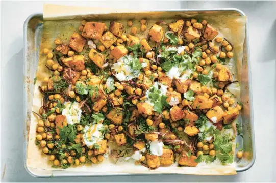  ?? DAVID MALOSH/THE NEW YORK TIMES ?? Crunchy spiced chickpeas complement roasted cubes of squash in this sheet-pan meal.