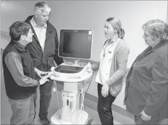  ?? SUBMITTED PHOTO ?? Western Hospital nurse Justina Gaudet explains the functions of a point-of-care ultrasound unit to Western Hospital Foundation members, Krystyna Pottier (left), Dave McKenna and Marlene Bolger. The foundation contribute­d funds towards the purchase of the mobile unit.