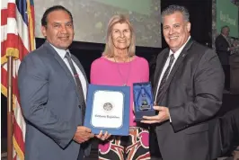  ?? SANDY SWETT, SPECIAL TO THE DESERT SUN ?? Edwin Gomez, Riverside County Superinten­dent of Schools, and Sean Webb, Read With Me Volunteers executive director, present the annual Palm Desert Area Chamber of Commerce Citizen of the Year award to volunteer Pat Harris.