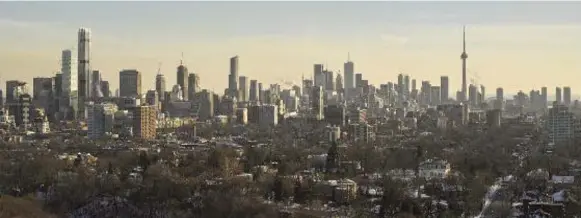  ?? MIZRAHI DEVELOPMEN­TS ?? An artist’s rendering shows The One towering over other Yonge-Bloor buildings on the left. Only the CN Tower will eclipse the height of the new 80-storey condo building.