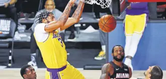  ??  ?? Los Angeles Lakers forward Anthony Davis dunks the ball during Game 4 of the NBA Finals, in Lake Buena Vista, Florida, U.S., Oct. 6, 2020.