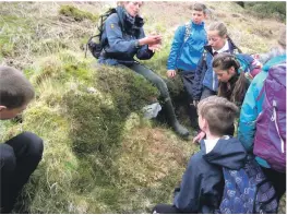  ??  ?? Above: Arran ranger Corinna Goeckeritz teaches the children about sphagnum moss.