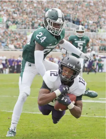  ?? AP ?? NU receiver JJ Jefferson hauls in a 34-yard touchdown pass in the second quarter against Michigan State.