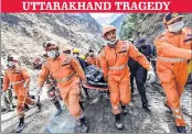  ?? —PTI ?? NDRF personnel carry the body of a victim who died near Raini village in Chamoli district of Uttarakhan­d on Tuesday.