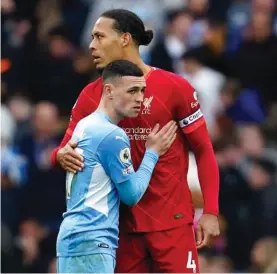  ?? ?? Liverpool's Virgil van Dijk, right, hugs Manchester City's Phil Foden at the end of the English Premier League soccer match between Manchester City and Liverpool