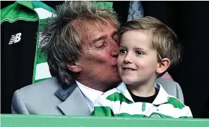  ??  ?? Can’t win them all: Sir Rod plants a kiss on son Aiden at Parkhead