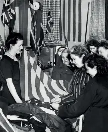  ??  ?? LEFT A local store sees a rush for flags and bunting as the people of Coventry prepare for the peace celebratio­ns. April 9, 1945