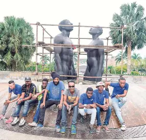  ?? CONTRIBUTE­D ?? Neville Authers (fourth right) and his team take a break from working on the restoratio­n of the ‘Redemption Song’ statue at Emancipati­on Park.