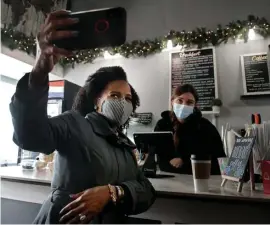  ?? NAncy lAnE / hErAld stAFF ?? PHOTO OP: Acting Mayor Kim Janey takes a selfie with AK Grosse at Deja Brew on East Broadway in South Boston on Thursday.