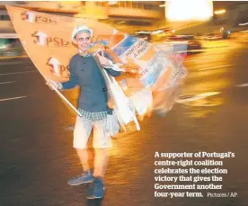  ?? Pictures / AP ?? A supporter of Portugal’s centre-right coalition celebrates the election victory that gives the Government another four-year term.