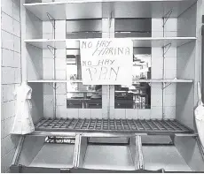  ??  ?? In this March 20 photo, a handwritte­n message that reads in Spanish, ‘No flour. No bread’, is taped to the edge of an empty shelf at a privately owned bakery in Caracas, Venezuela. Russia is offering to alleviate Venezuela’s food-shortage crisis.