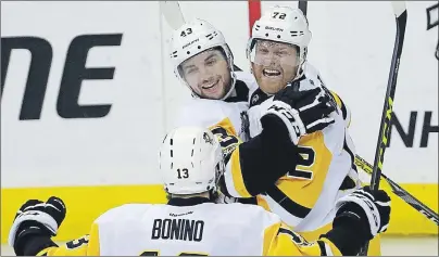 ?? AP PHOTO ?? Pittsburgh Penguins left wing Conor Sheary (left) and right wing Patric Hornqvist celebrate with center Nick Bonino after Hornqvist’s goal during the third period of Game 7 in an NHL Stanley Cup Eastern Conference semifinal against the Washington...
