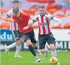  ??  ?? Dundee United’s Adam King battles with Sheffield United’s John Fleck for possession.