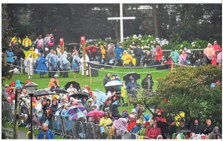  ?? Ireland. — Reuters ?? Come rain or shine: Faithful believers waiting in the rain ahead of a visit by Pope Francis to Knock Shrine in Knock,