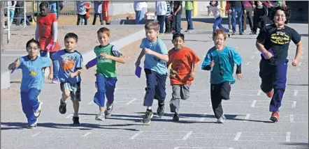  ?? DEAN HANSON/JOURNAL ?? Some of the students with Sierra Vista Elementary School’s runners club take laps around the playground recently. The running program has about 300 regular participan­ts. “I saw a lot of kids not being active for one reason or another, outside of school...