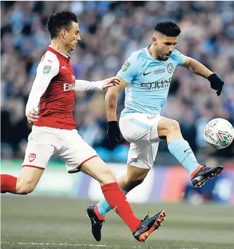  ?? AP ?? Manchester City’s Sergio Aguero (right) scores the opening goal during the English League Cup final between Arsenal and Manchester City at Wembley Stadium in London,yesterday. City won 3-0.