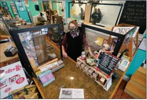  ?? (AP/Steve Helber) ?? Victoria Leigh Kidd, owner of Hideaway Cafe, greets customers from behind protective shields in her shop in the Old Town area of Winchester, Va. The pandemic has hammered small businesses across the United States, an alarming trend for an economy that’s trying to rebound from the deepest, fastest recession in U.S. history.