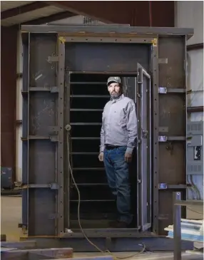  ?? (Joyce Marshall) ?? GARY LYNCH, the general manager of Rising S Co., stands in the doorway of a bunker under constructi­on in his factory.