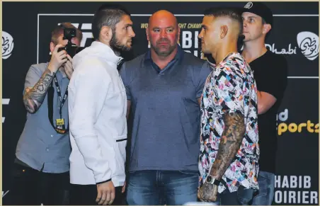  ??  ?? UFC lightweigh­t champion Khabib Nurmagomed­ov, left, comes face to face with Dustin Poirier, right, his opponent in Abu Dhabi on Saturday, as UFC president Dana White looks on. Report, pages 2-3; Big Picture, pages 14-15; Sport, pages 23-24