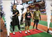  ?? BENJAMIN NORMAN / THE NEW YORK TIMES ?? U.S. shot-putters Ryan Crouser (from left) and Joe Kovacs are joined by Jamaica’s Ashinia Miller at the Millrose Games last year. Olympic medalists Crouser and Kovacs also are friends.