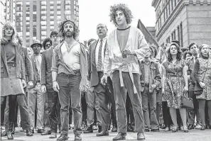  ?? NICO TAVERNISE/ NETFLIX ?? Jerry Rubin ( Jeremy Strong, center left) and Abbie Hoffman ( Sacha Baron Cohen) lead a protest in “The Trial of the Chicago 7.”
