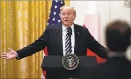  ?? Alex Brandon Associated Press ?? TRADE deficits are “not everything, and they’re not exact,” President Trump, pictured during a news conference with the Polish president, said Tuesday.