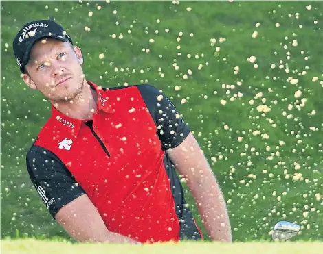  ?? Picture: Getty. ?? Joint halfway leader Danny Willett, the 2016 Masters champion, plays his third shot on the 18th.