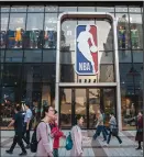  ?? PHOTO BY KEVIN FRAYER/GETTY IMAGES/TNS ?? People walk by the NBA flagship retail store on October 9, 2019 in Beijing, China.