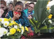  ?? Moises Castillo / Associated Press ?? Haydee Posadas cries during a funeral for her son, Wilmer Nunez, at a cemetery in San Pedro Sula.