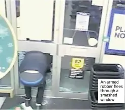  ??  ?? An armed robber flees through a smashed window