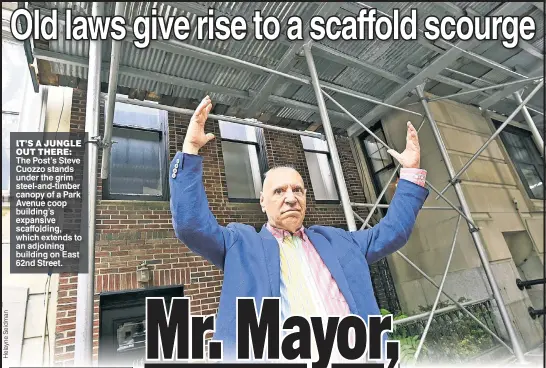  ?? ?? IT’S A JUNGLE OUT THERE: The Post’s Steve Cuozzo stands under the grim steel-and-timber canopy of a Park Avenue coop building’s expansive scaffoldin­g, which extends to an adjoining building on East 62nd Street.