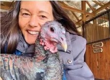  ?? ?? Laks with Adeline, one of the female rescue turkeys living at the Gentle Barn.