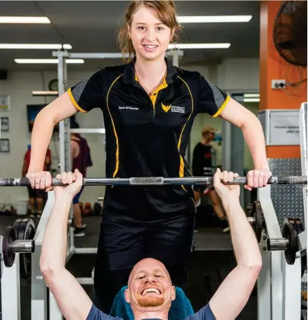  ?? Photo: USQ Photograph­y ?? GRADUATION CEREMONY: USQ sports and exercise graduand Zoe Sengstock puts Adam Sparks through his paces.