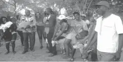  ??  ?? Zanu-PF Youth League national executive member Cde Mbongeni Dube (in black shirt) after handing over some of the goats to provincial chair for Matabelela­nd North Cde Tamuka Nyoni and other members in Monde