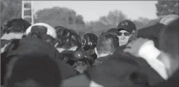  ?? Arkansas Democrat-Gazette/MITCHELL PE MASILUN ?? Harding Coach Ronnie Huckeba, who is in his 10th and final season coaching the Bisons, talks with his team after a first-round NCAA Division II playoff victory over Central Missouri State in Searcy.