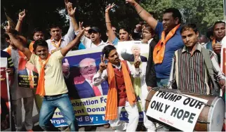  ??  ?? NEW DELHI: Right-wing activists of India’s Hindu Sena celebrate the victorious outcome for US Republican presidenti­al candidate Donald Trump in the US presidenti­al elections in New Delhi yesterday. —AFP