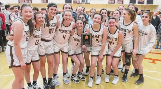  ?? Peter Wallace/For Hearst Connecticu­t Media ?? Members of the Thomaston girls basketball team celebrate after defeating Northweste­rn for the Berkshire League tournament title Friday at Terryville High School.