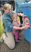  ?? Photograph: Iain Ferguson, alba.photos ?? Susannah Calderan and Russell Leaper, right, were distributi­ng the new bin stickers, with help from Joanne Mackin and her daughter Isabelle, left.