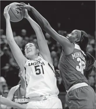  ?? SEAN D. ELLIOT/THE DAY ?? In this Nov. 17, 2016, file photo, UConn’s Natalie Butler (51) beats Baylor’s Beatrice Mompremier to a rebound in a game at Gampel Pavilion in Storrs.